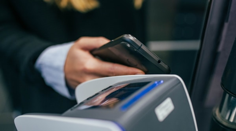 A person holding a smartphone, the device that opens a .pkpass file natively